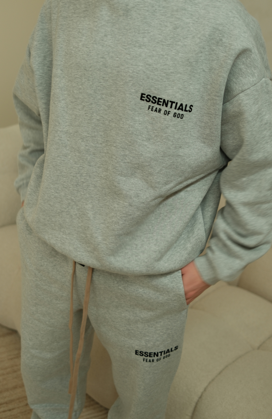 Fear of God Essentials mens fleece crewneck in heather grey worn by model back view