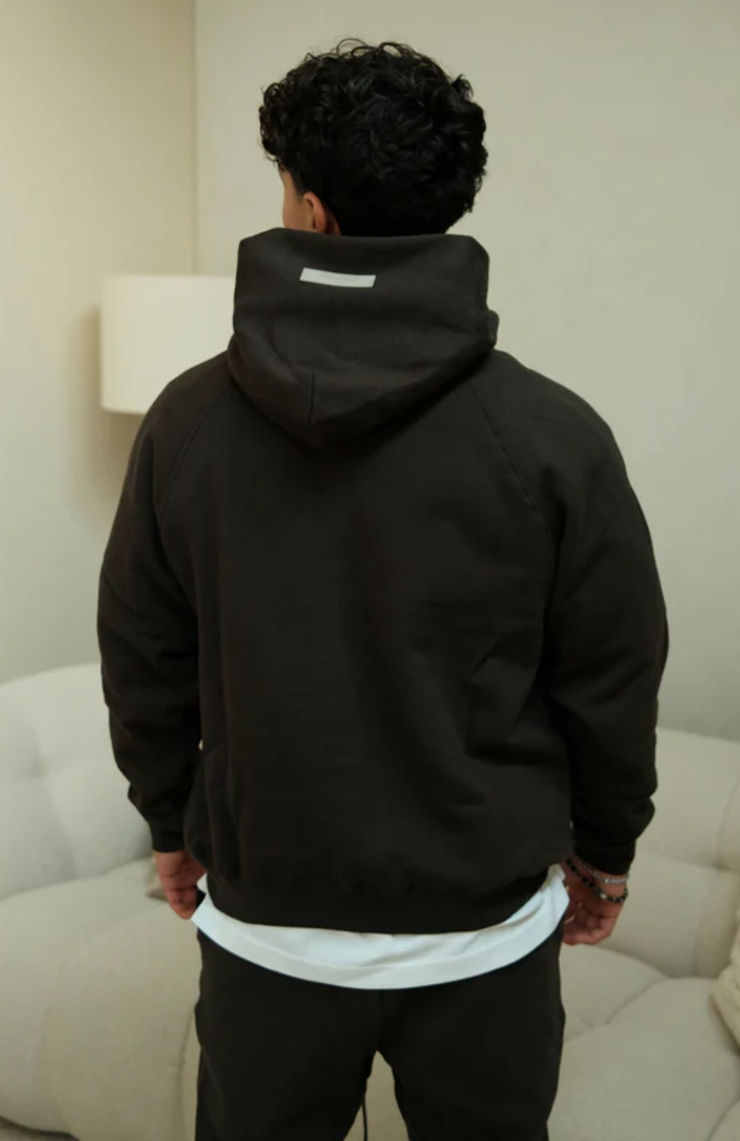 Fear of God ESSENTIALS 1977 hoodie and sweatpants set in iron black worn by model back view