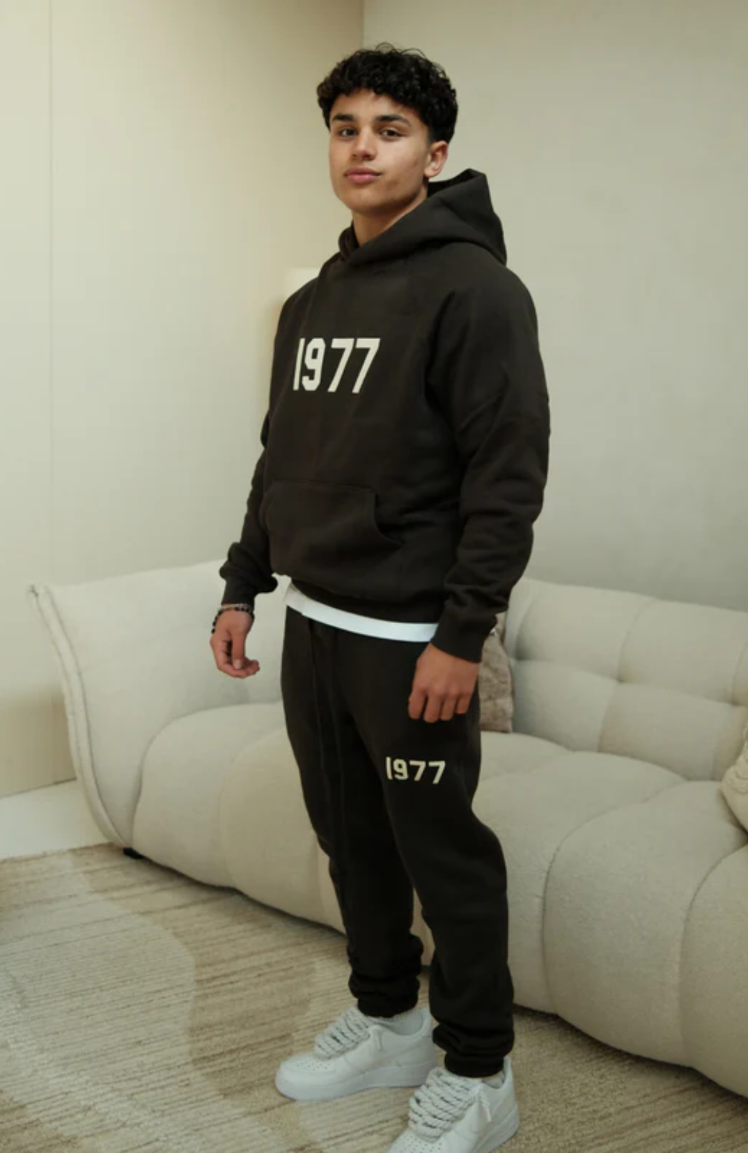 Fear of God ESSENTIALS 1977 hoodie and sweatpants set in iron black worn by model