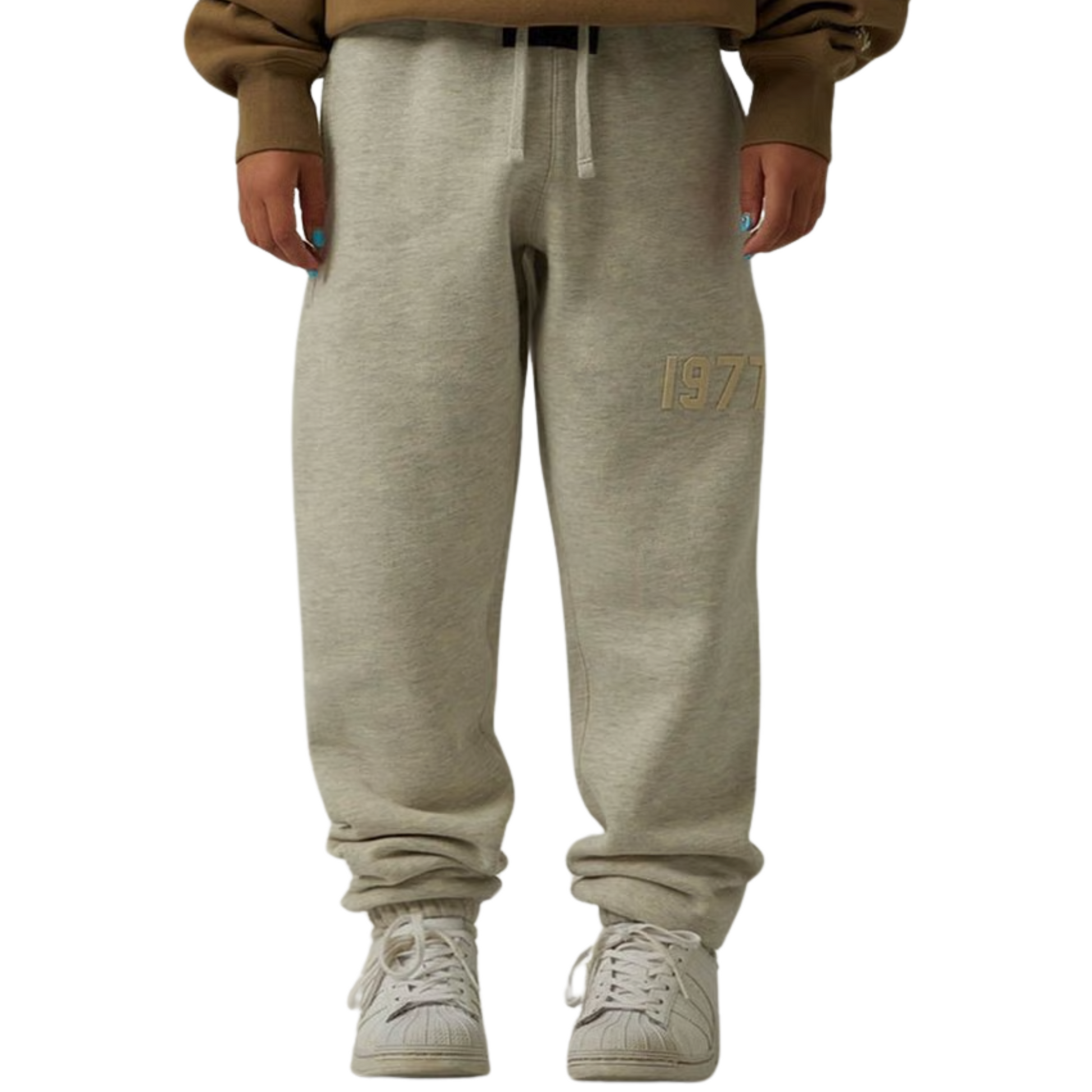 Fear of God Essentials 1977 sweatpants in light oatmeal worn by model front view