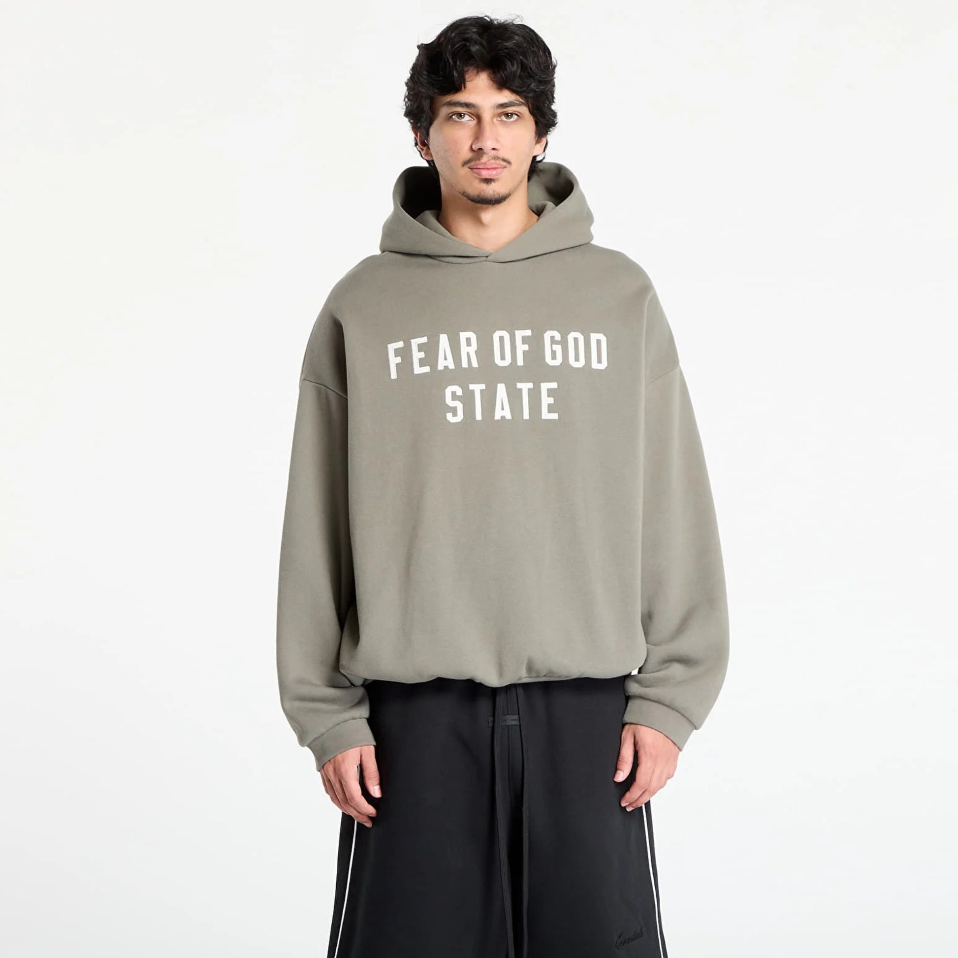 Fear of God Essentials 90s hoodie in moss worn by model