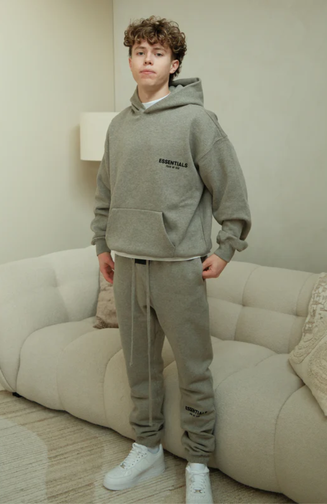 Fear of God ESSENTIALS hoodie and sweatpants set in dark oatmeal worn by model front view