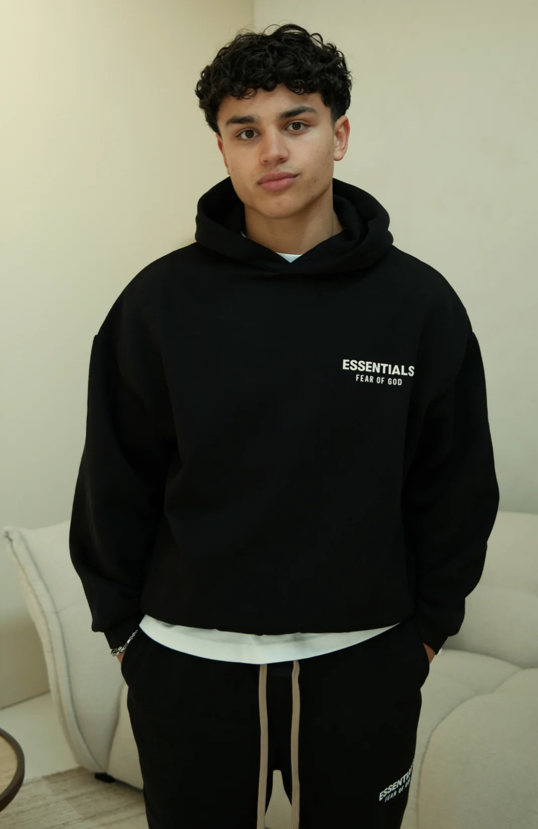 Fear of God ESSENTIALS hoodie and sweatpants set in black white worn by model front view