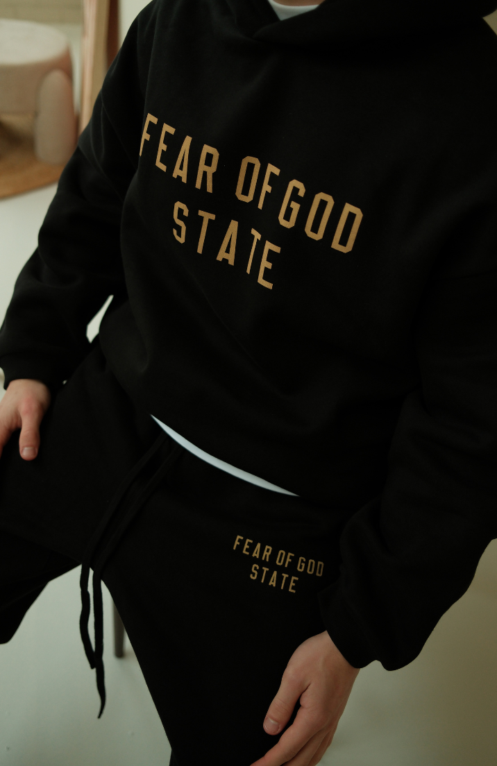 Fear of God ESSENTIALS hoodie and sweatpants set in black worn by model detail view
