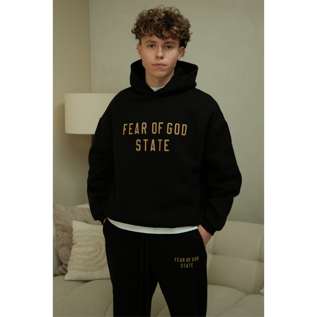 Fear of God Essentials FW24 hoodie in black front view