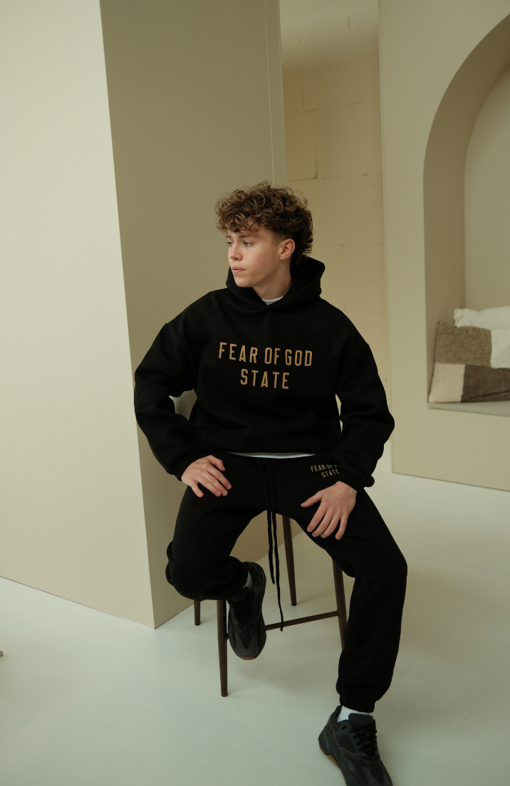 Fear of God ESSENTIALS hoodie and sweatpants set in black sitting