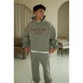Fear of God Essentials FW24 hoodie and sweatpants set in dark heather worn by model front view