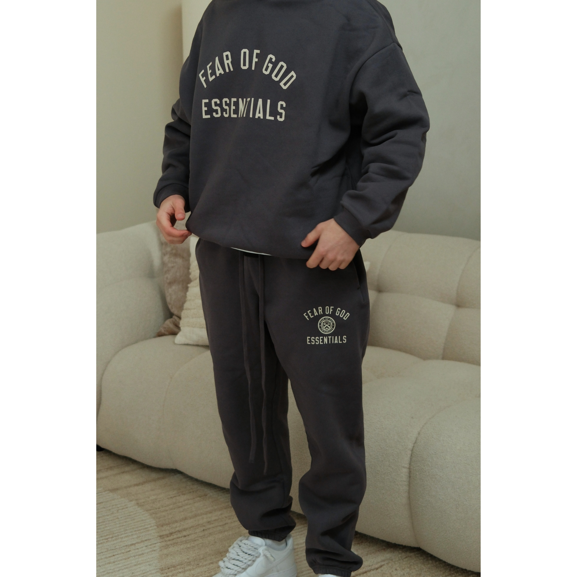 Fear of God Essentials FW24 hoodie and sweatpants set in marine detail on model