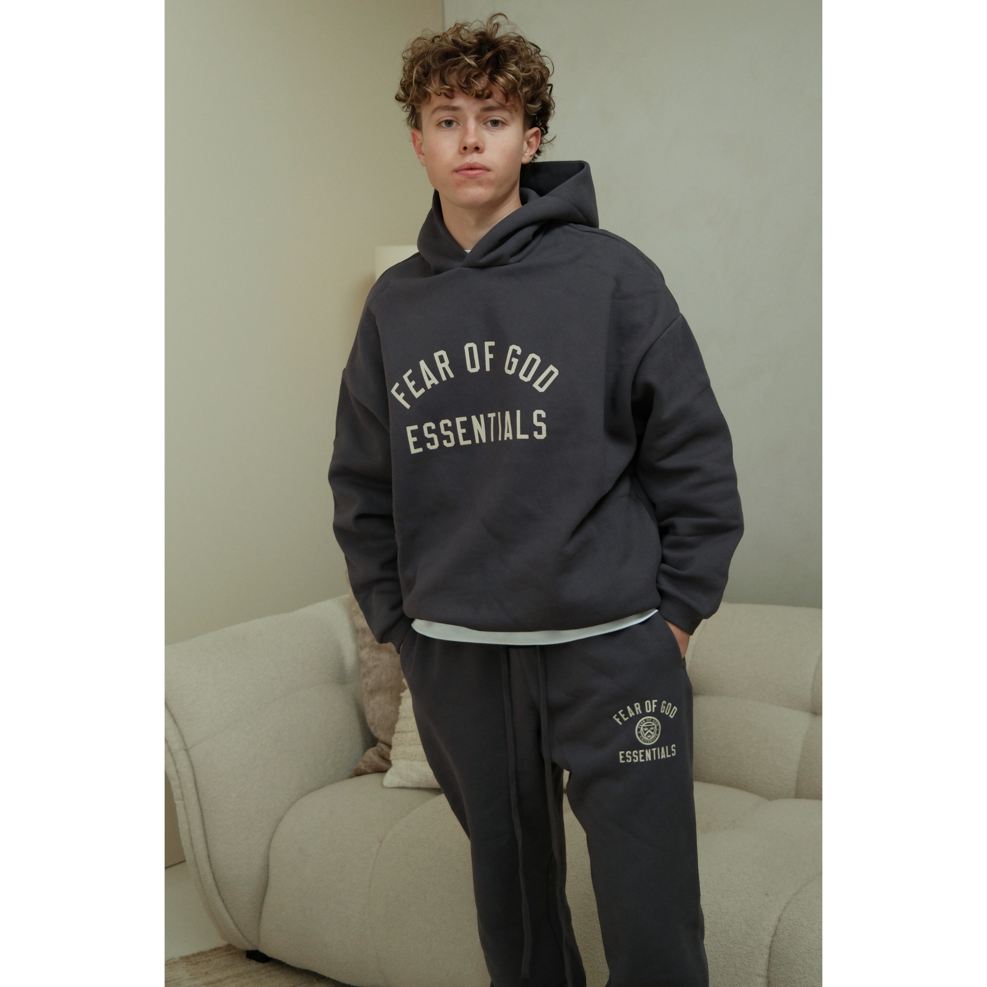 Fear of God Essentials FW24 hoodie and sweatpants set in marine on model front view