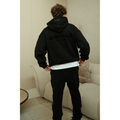 Fear of God Essentials hoodie and sweatpants set in limo black worn by model back view