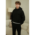 Fear of God Essentials hoodie and sweatpants set in limo black worn by model front view
