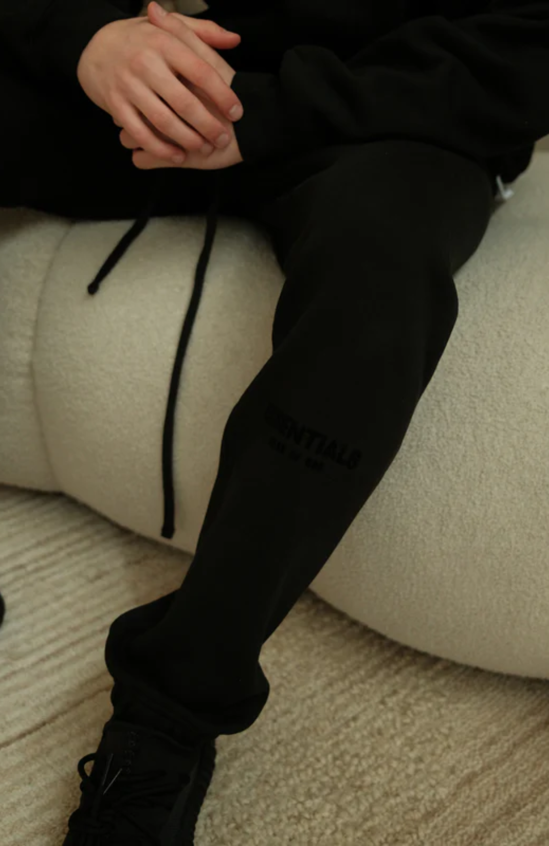 Fear of God Essentials Limo Black Full Set sweatpants in limo black worn by model detail view