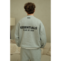 Fear of God Essentials mens fleece crewneck in heather grey worn by model back view