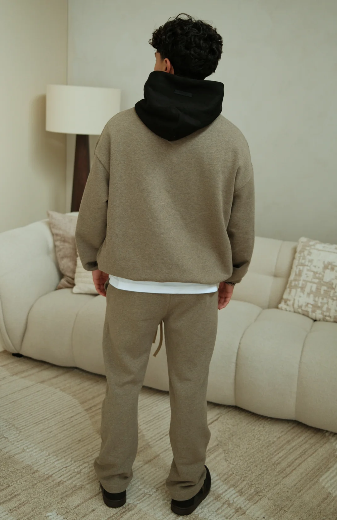 Fear of God ESSENTIALS NBA hoodie and sweatpants set in warm heather worn by model back view