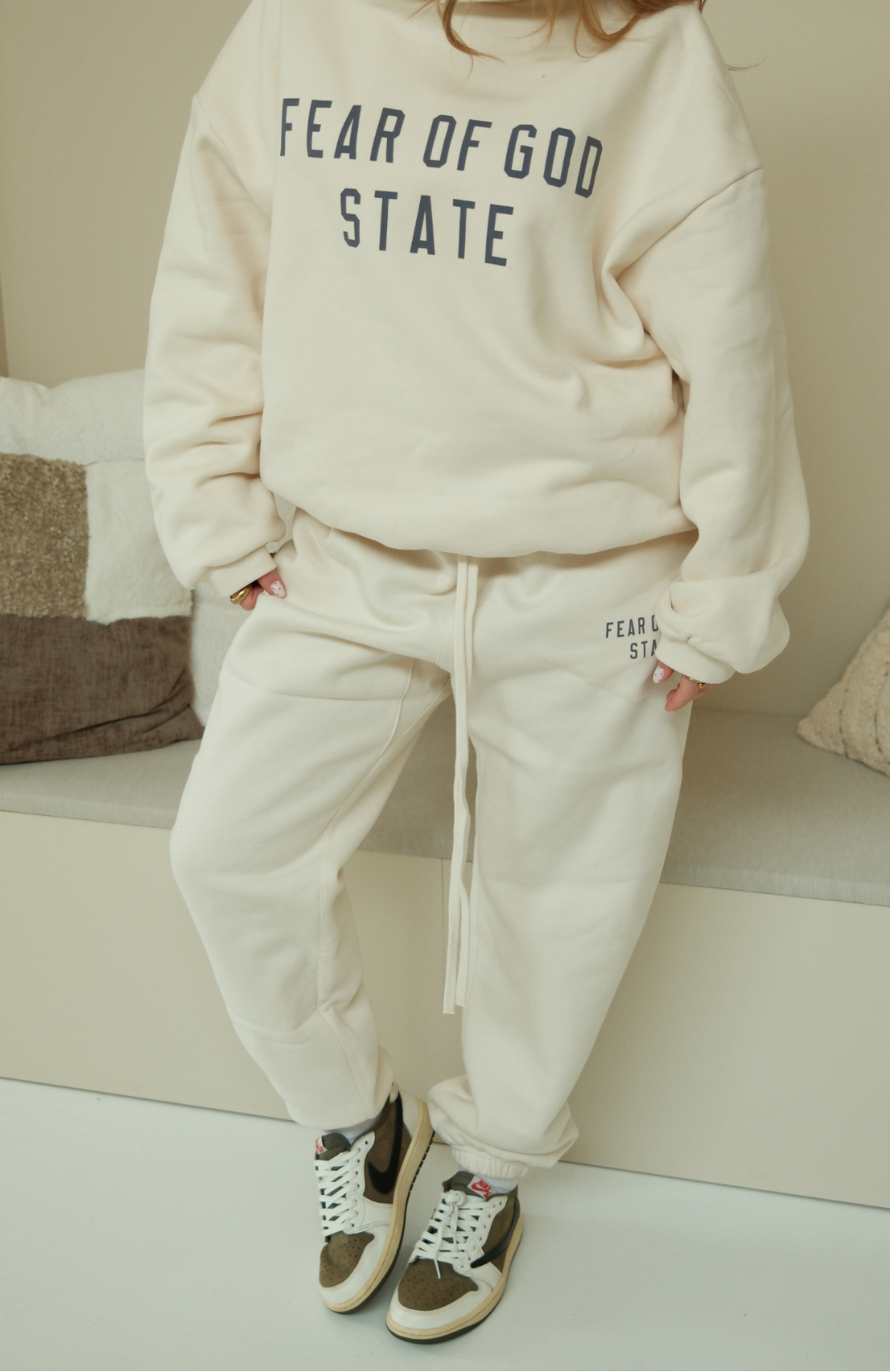 Fear of God Essentials Shell hoodie and sweatpants set in cream worn by model