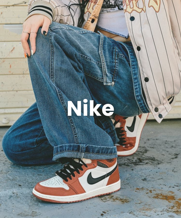 Nike sneakers worn by model in white and orange